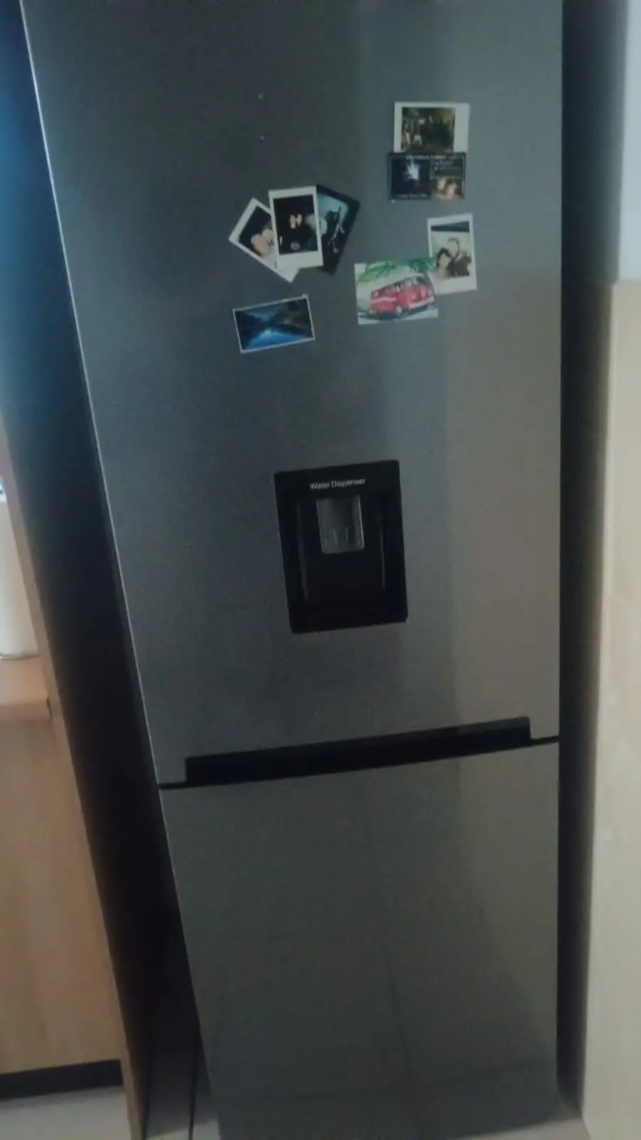 Black refrigerator with water dispenser serviced on site